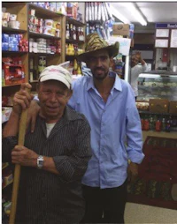 two men standing next to each other in a store